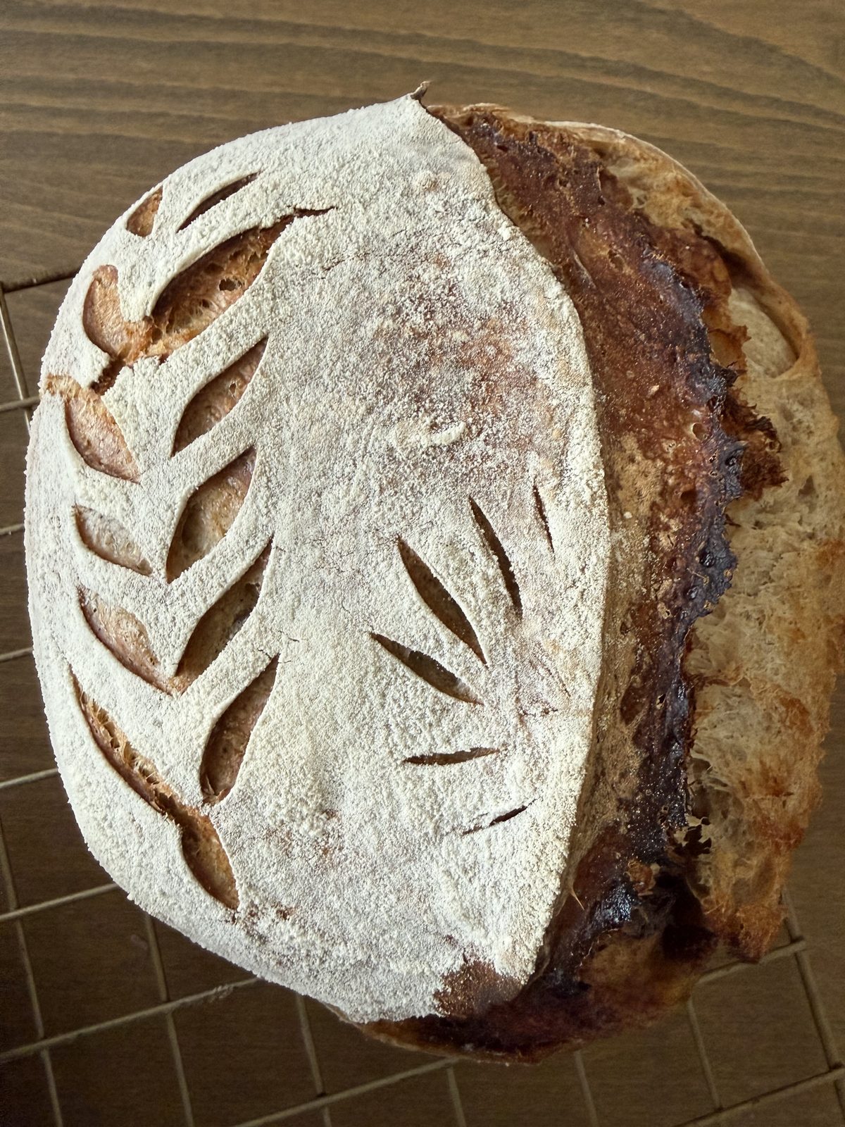 Flour-dusted work surface with freshly baked sourdough and baking tools